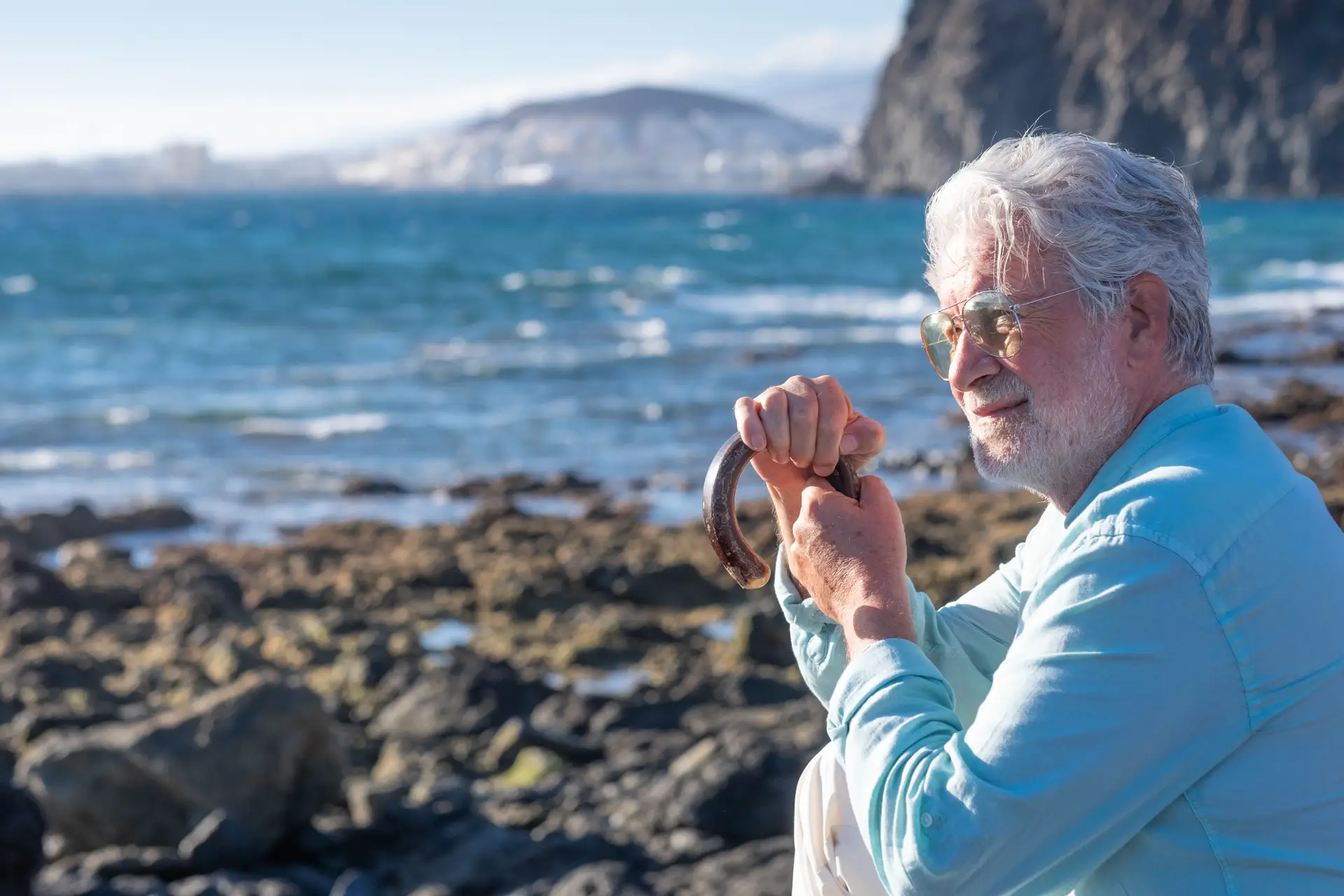 senior man white haired holding a walking cane senior man white haired holding a walking cane