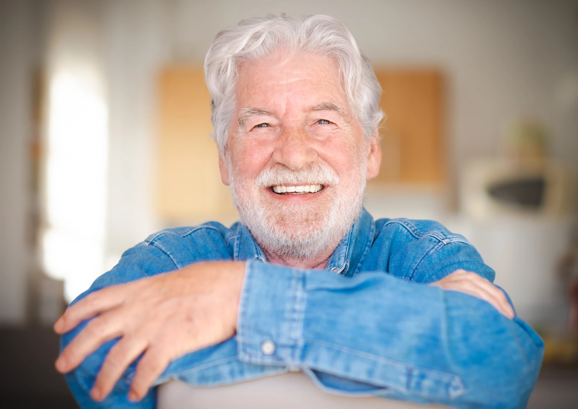 happy-senior-man-smiling-wearing-a-denim-shirt
