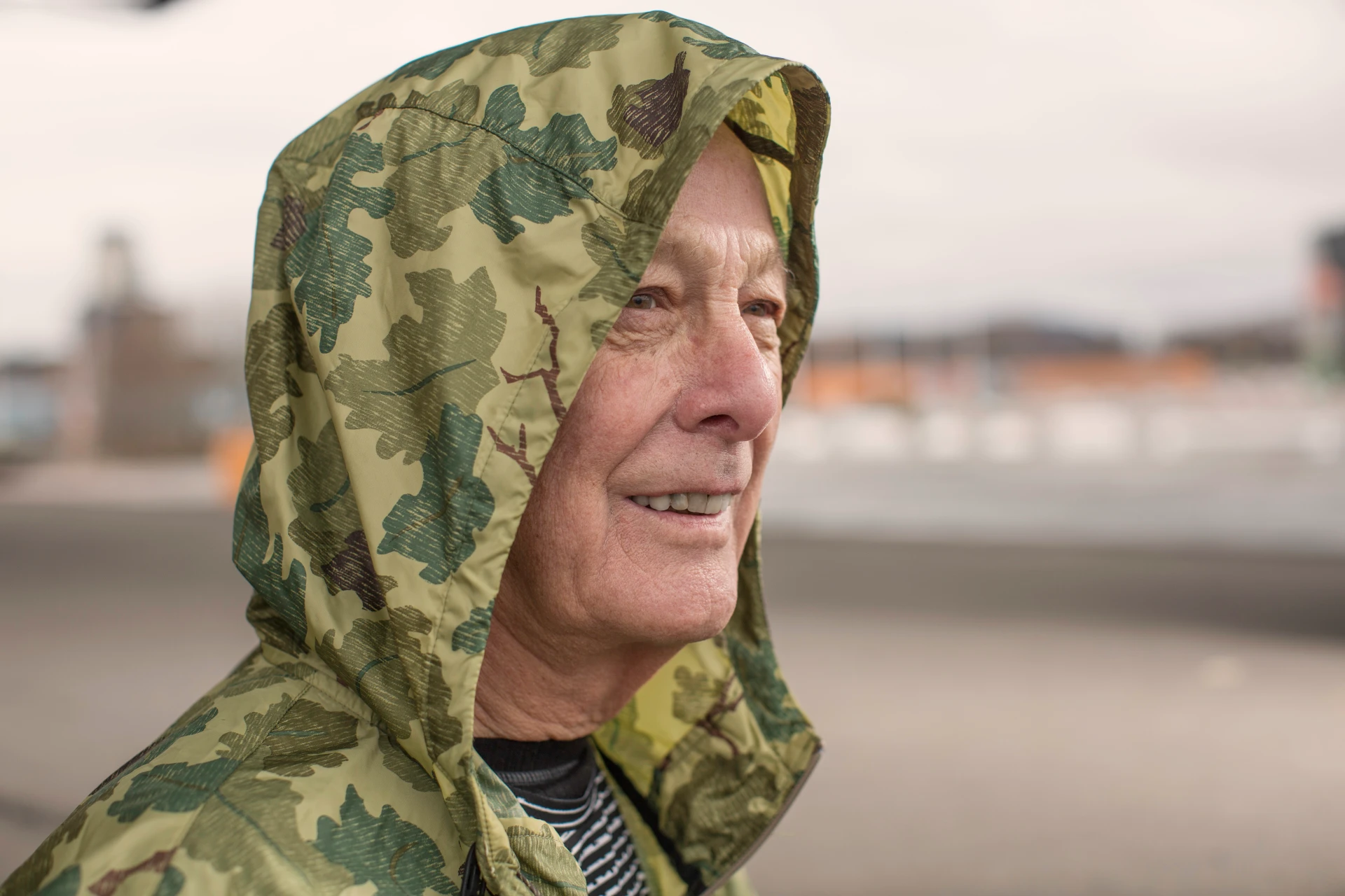 senior-man-outdoors-wearing-camouflage-raincoat